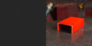 Red PFC steel displayed on a black counter, emphasising its durable and practical design. The vibrant red finish highlights the precision and strength of this steel section. Ideal for structural and construction applications, this PFC steel combines reliability with versatility.