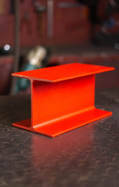 Red universal column positioned prominently on a sleek black counter, highlighting its robust and versatile structure. The vibrant red finish emphasises its durability and industrial appeal. Perfect for applications requiring strength and reliability, this universal column stands out as a key structural component.